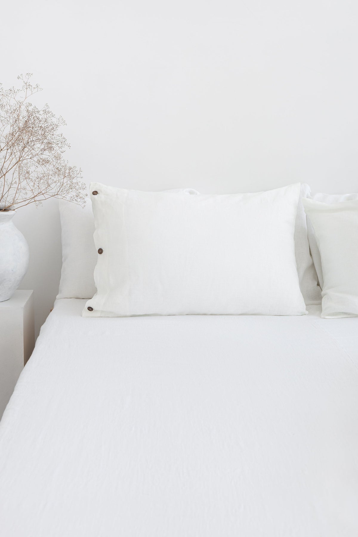 White linen pillowcase with coconut buttons